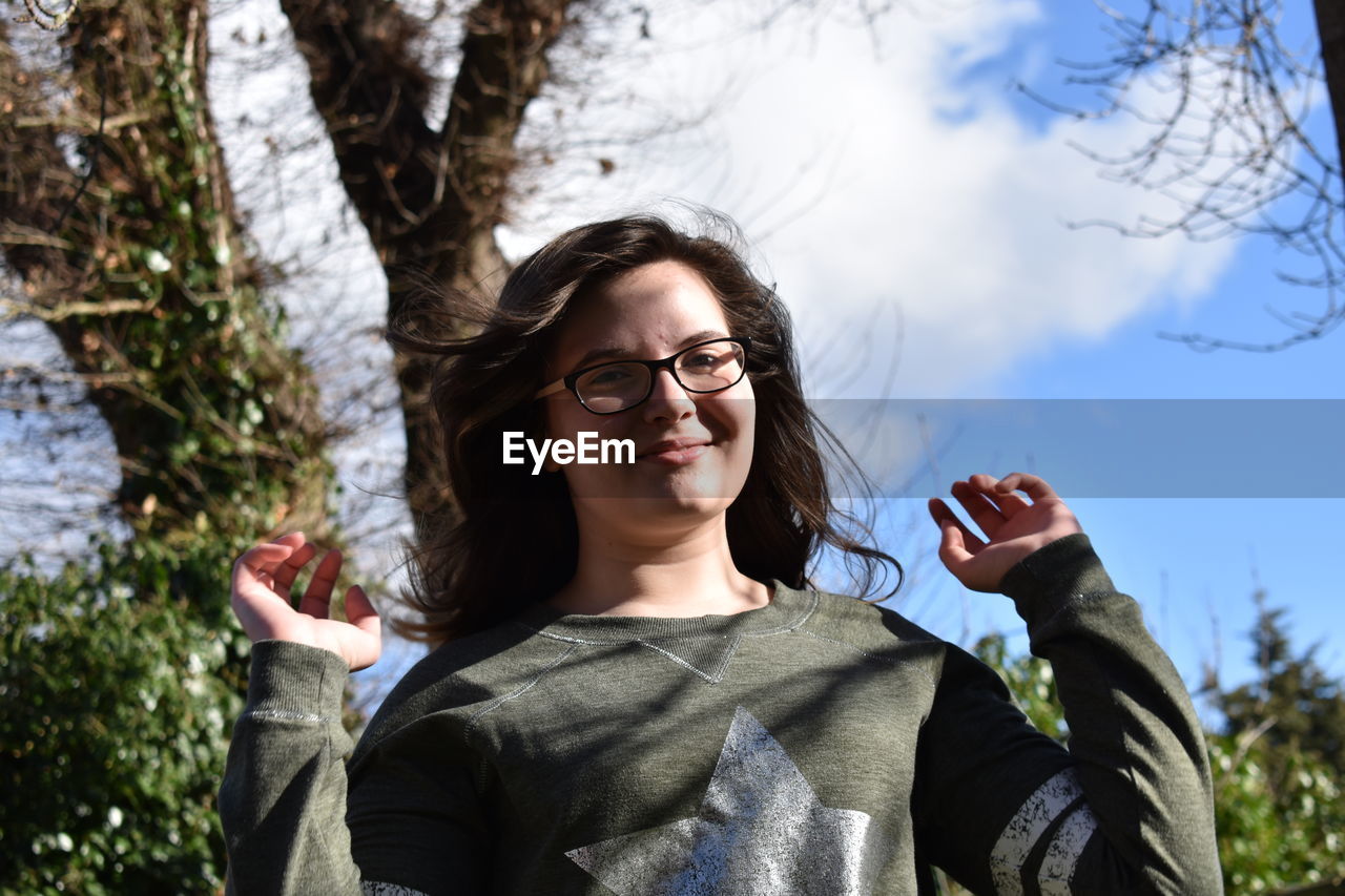 Portrait of smiling girl wearing eyeglasses in park