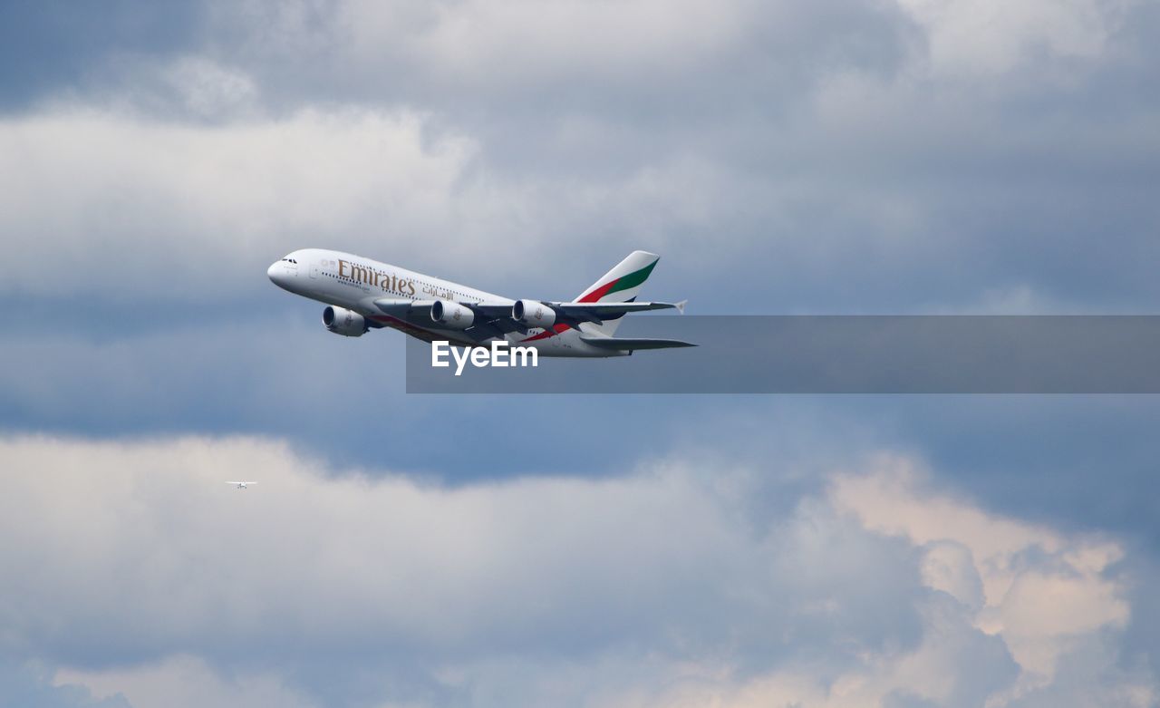 LOW ANGLE VIEW OF AIRPLANE AGAINST SKY