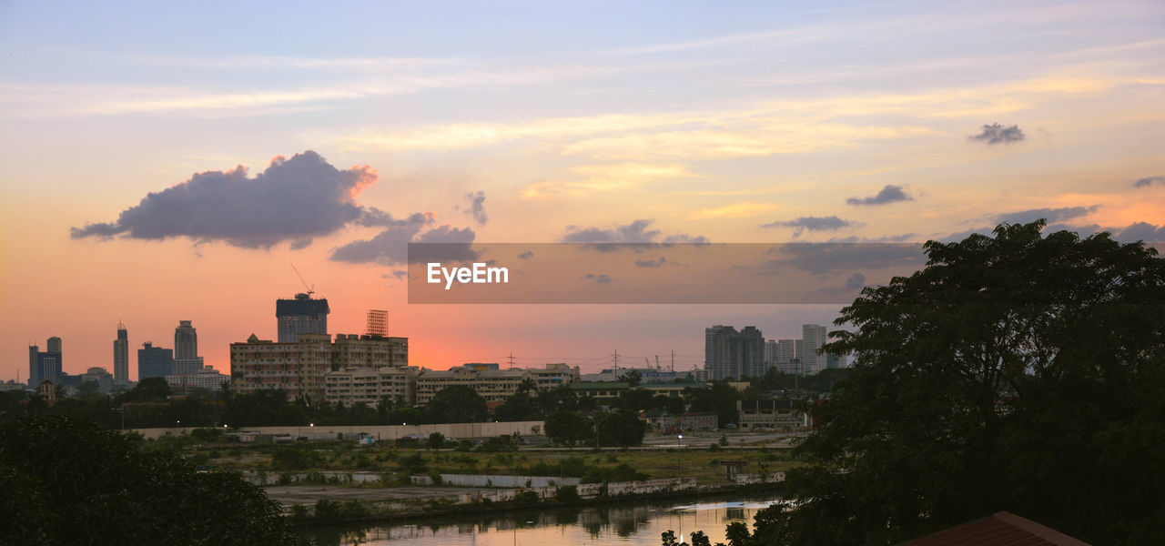 BUILDINGS AGAINST SKY DURING SUNSET