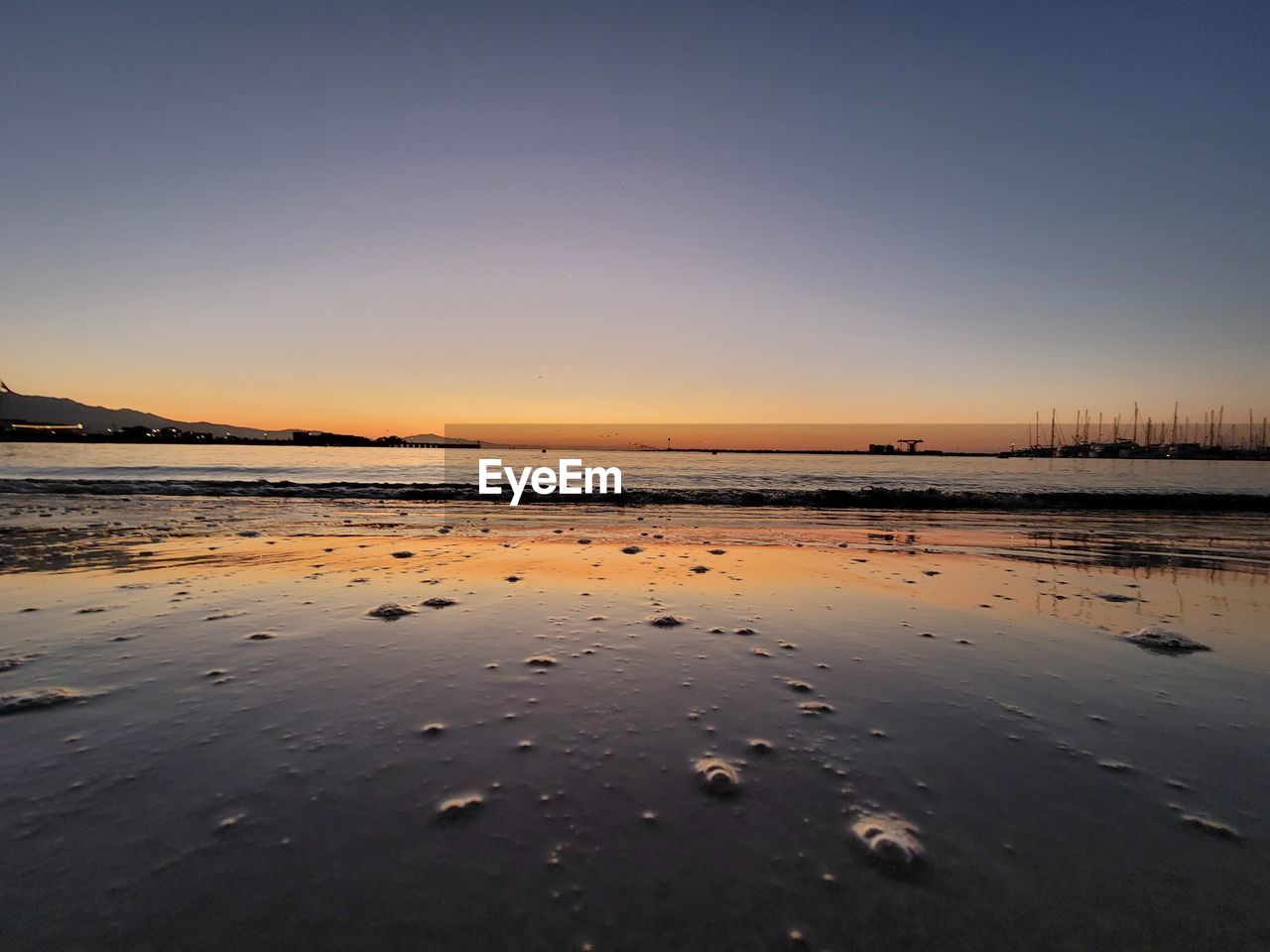 Scenic view of beach at sunset