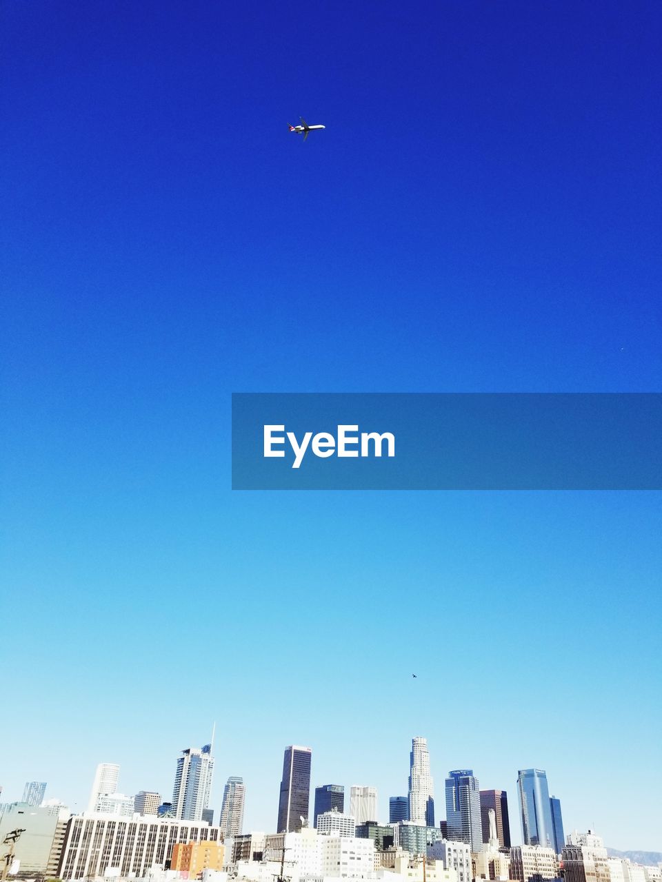 Low angle view of buildings against clear blue sky