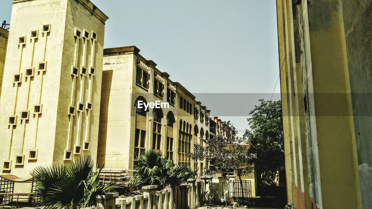 LOW ANGLE VIEW OF BUILDINGS AGAINST CLEAR SKY