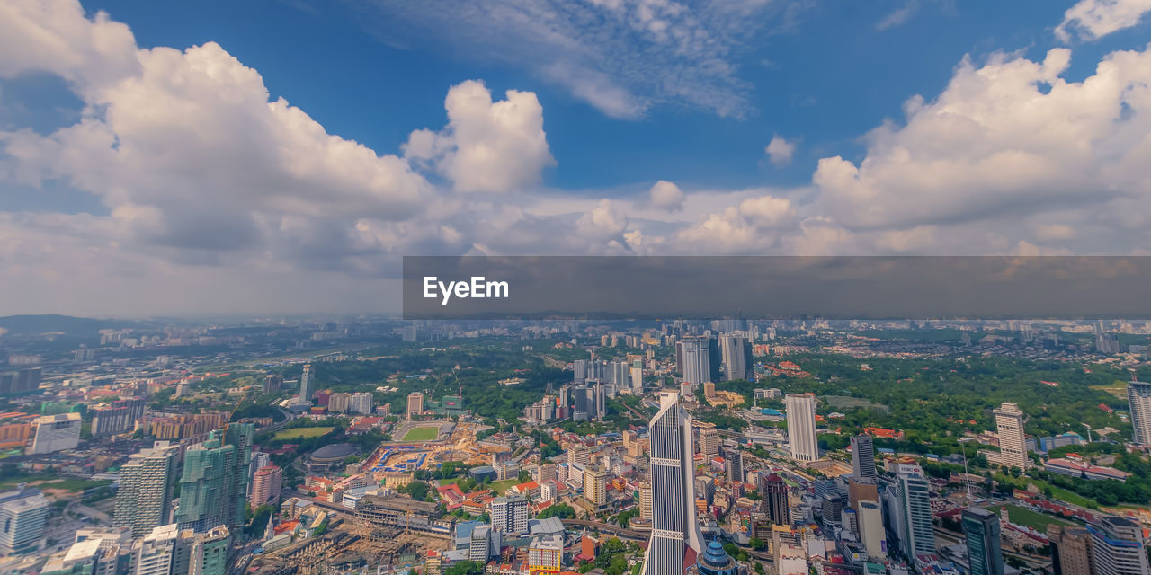 HIGH ANGLE VIEW OF CITY AGAINST SKY