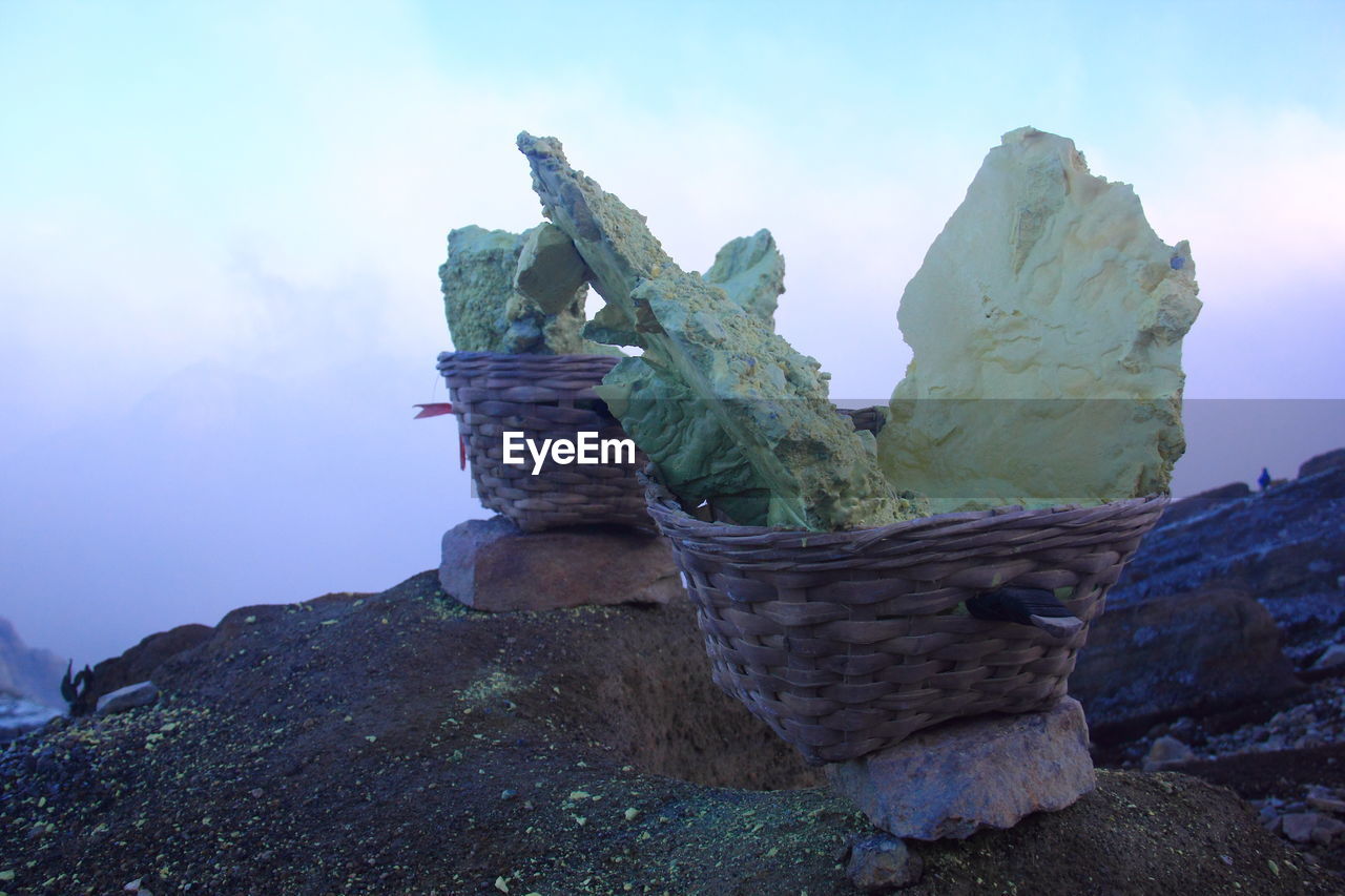 CLOSE-UP OF ROCK IN WICKER BASKET