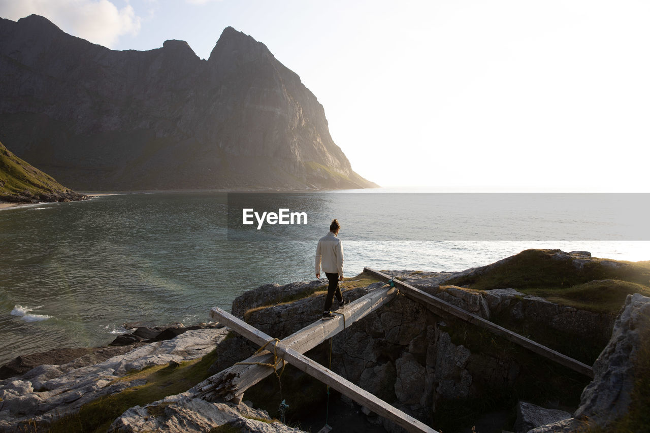 Man looking at sea against sky