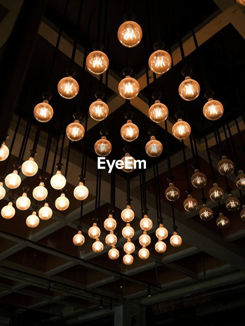 lighting equipment, light, lighting, low angle view, illuminated, hanging, ceiling, indoors, architecture, no people, large group of objects, decoration, built structure, lantern, light fixture, in a row, night, circle, chandelier, light bulb, building