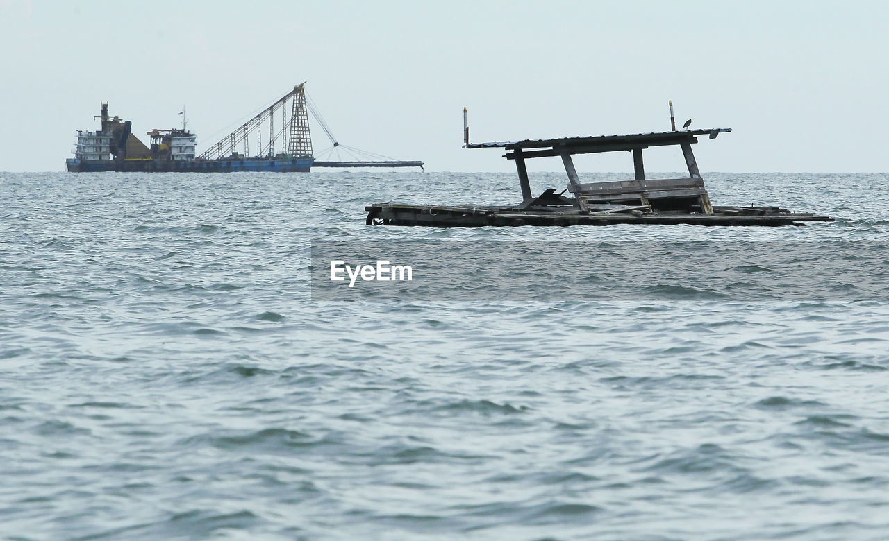 Ship sailing in sea against clear sky