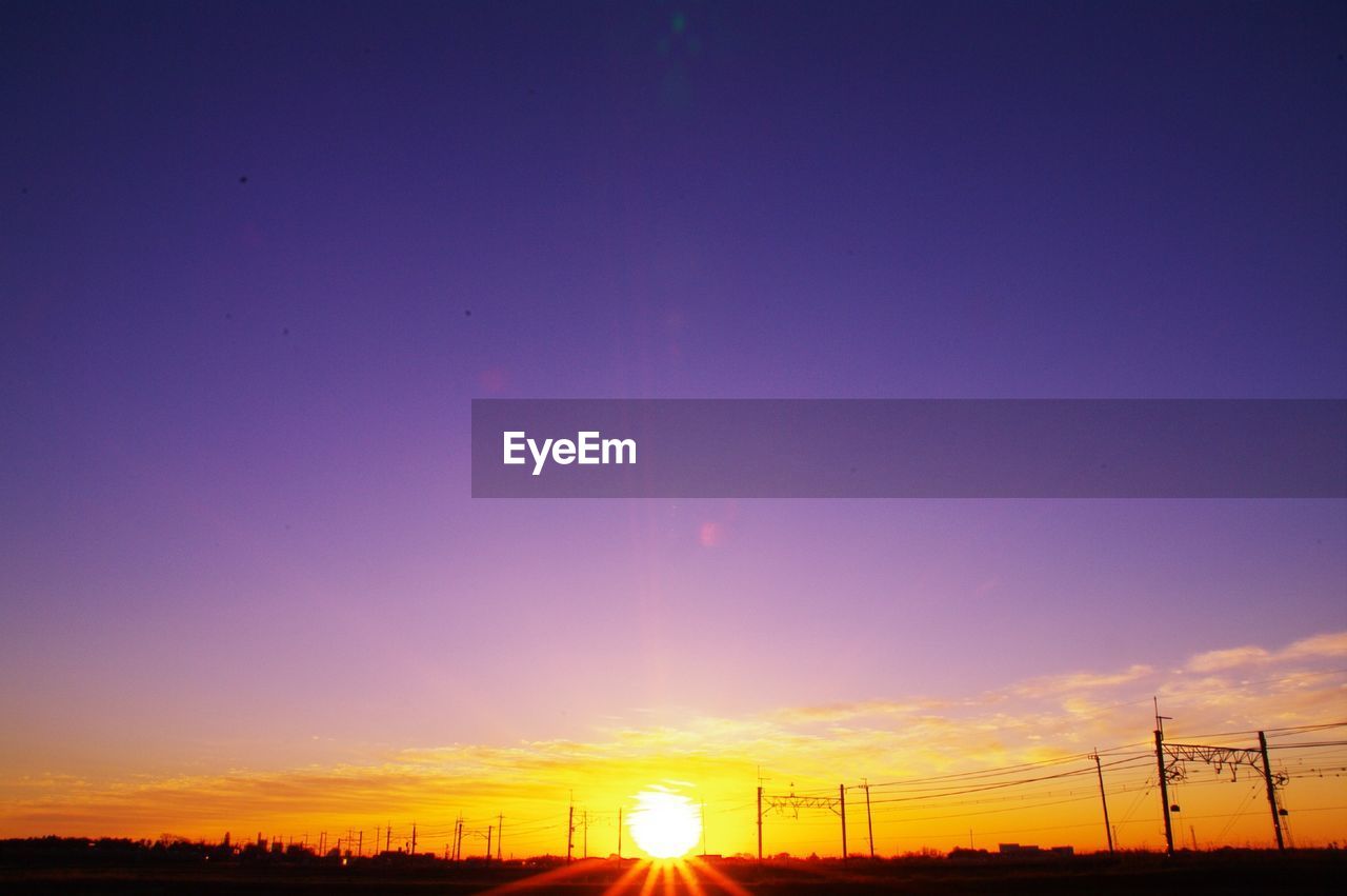 Silhouette field against sky during sunset