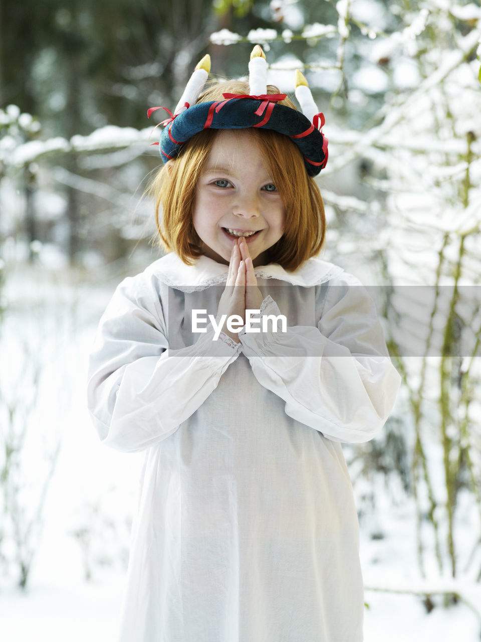 Girl wearing traditional lucia costume standing outdoors