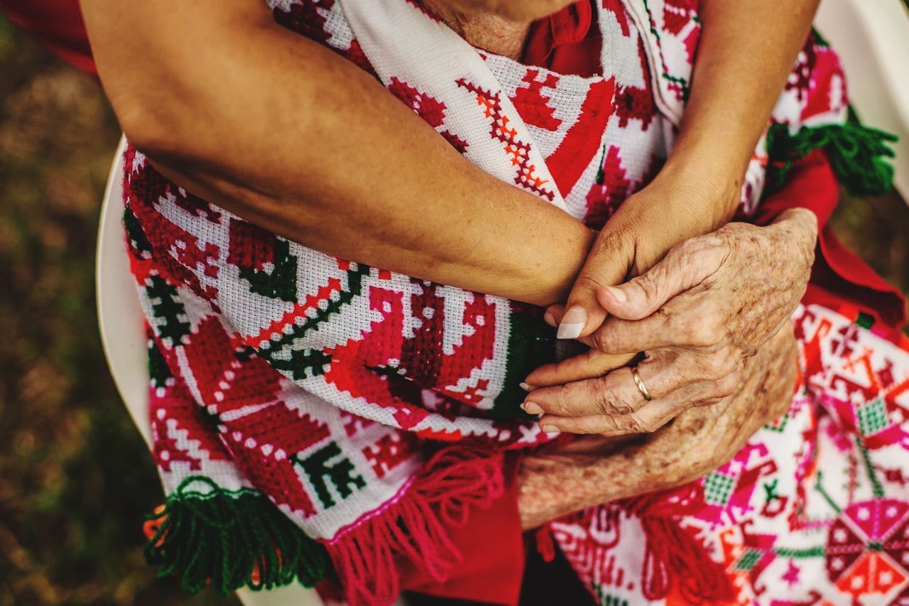 Midsection of woman holding hands