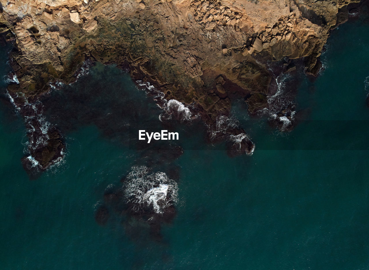 High angle view of rock formation by sea