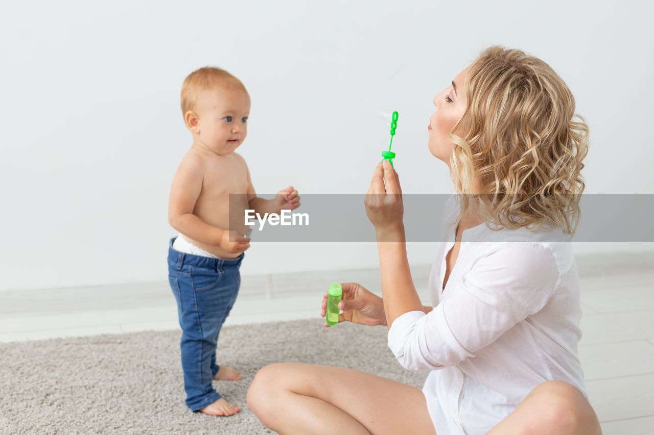 Mother playing with daughter at home