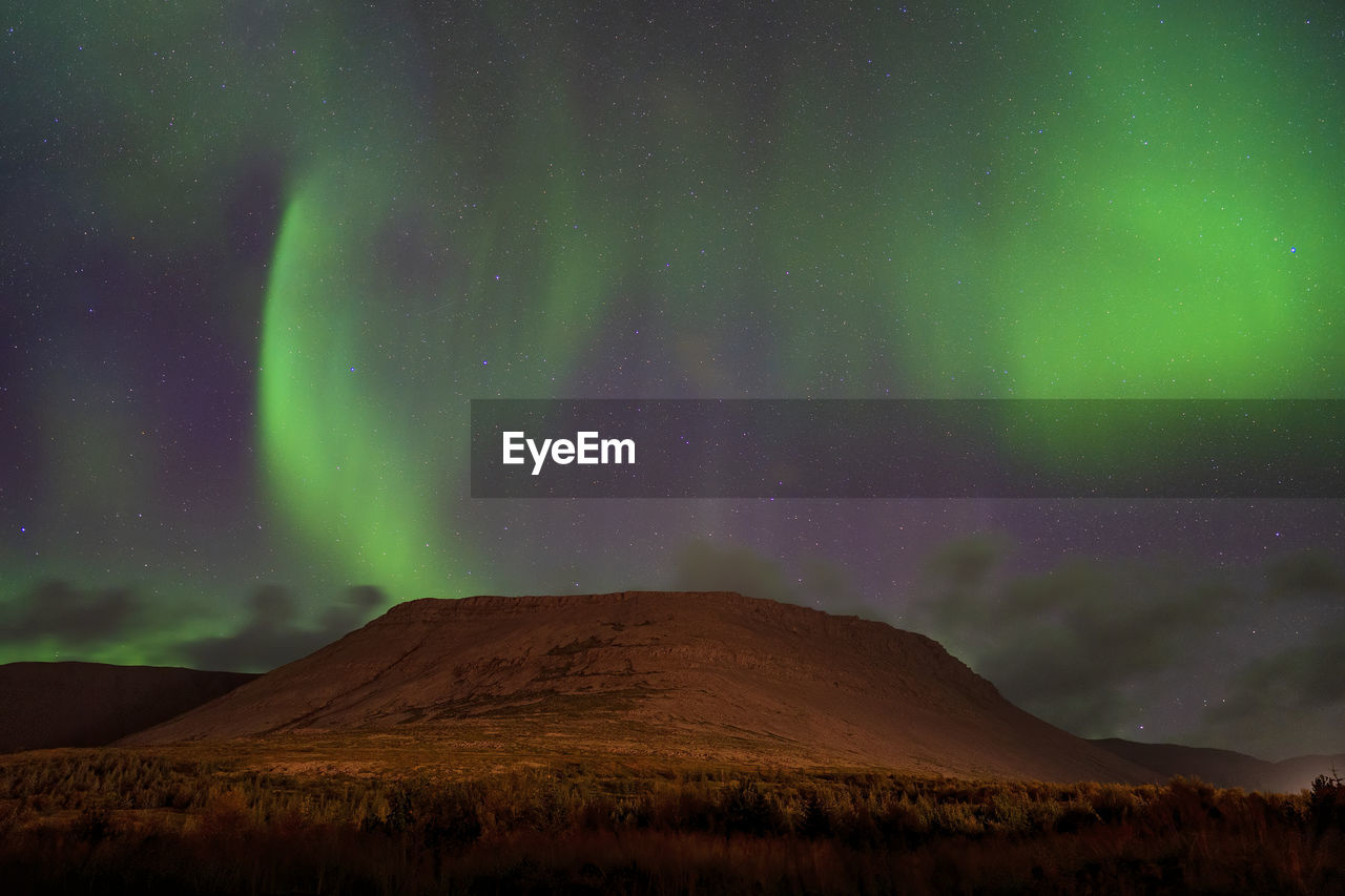 Low angle view of mountain against sky at night