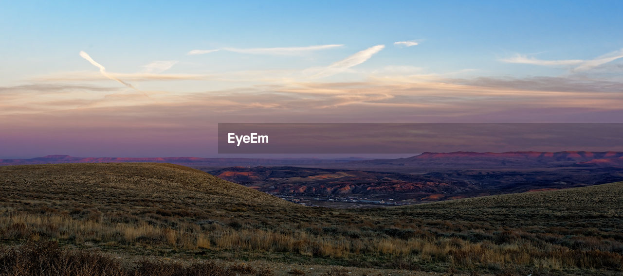 SCENIC VIEW OF LAND AGAINST SKY DURING SUNSET