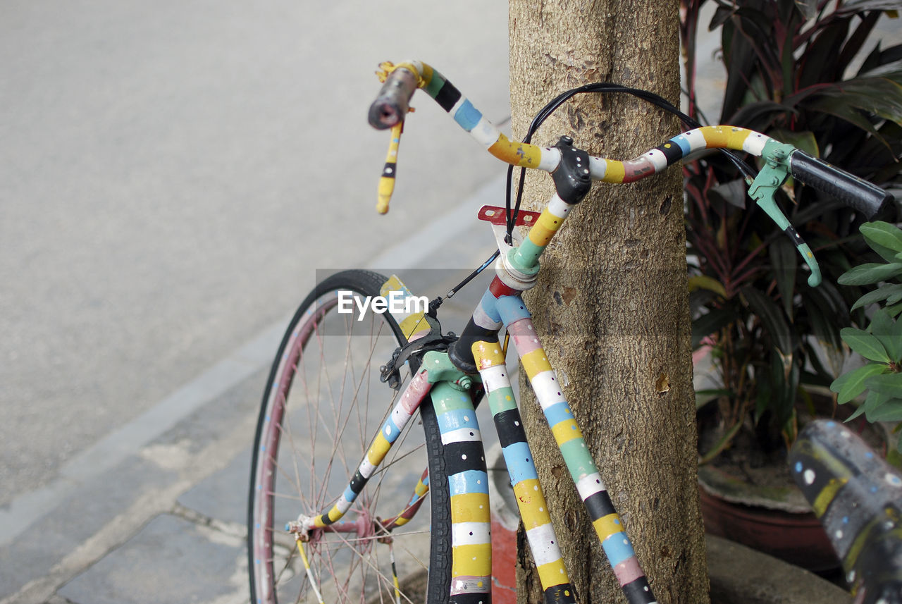 HIGH ANGLE VIEW OF BICYCLE PARKED BY BICYCLES