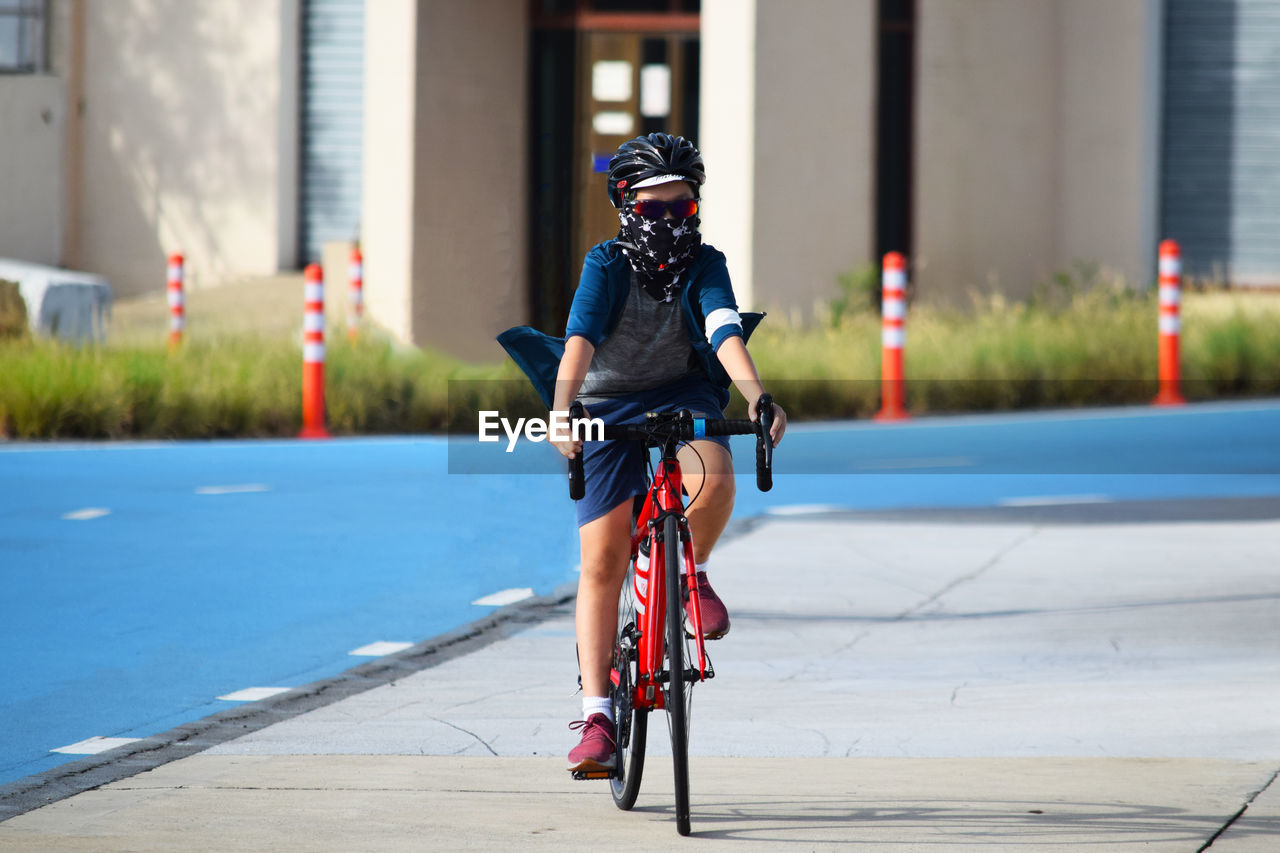 Man riding bicycle on city street