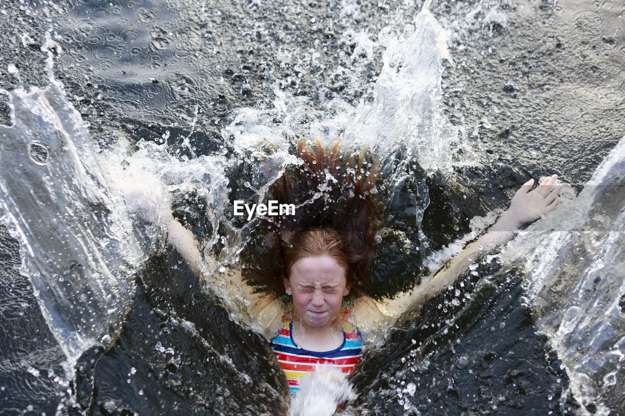 Girl splashing into sea