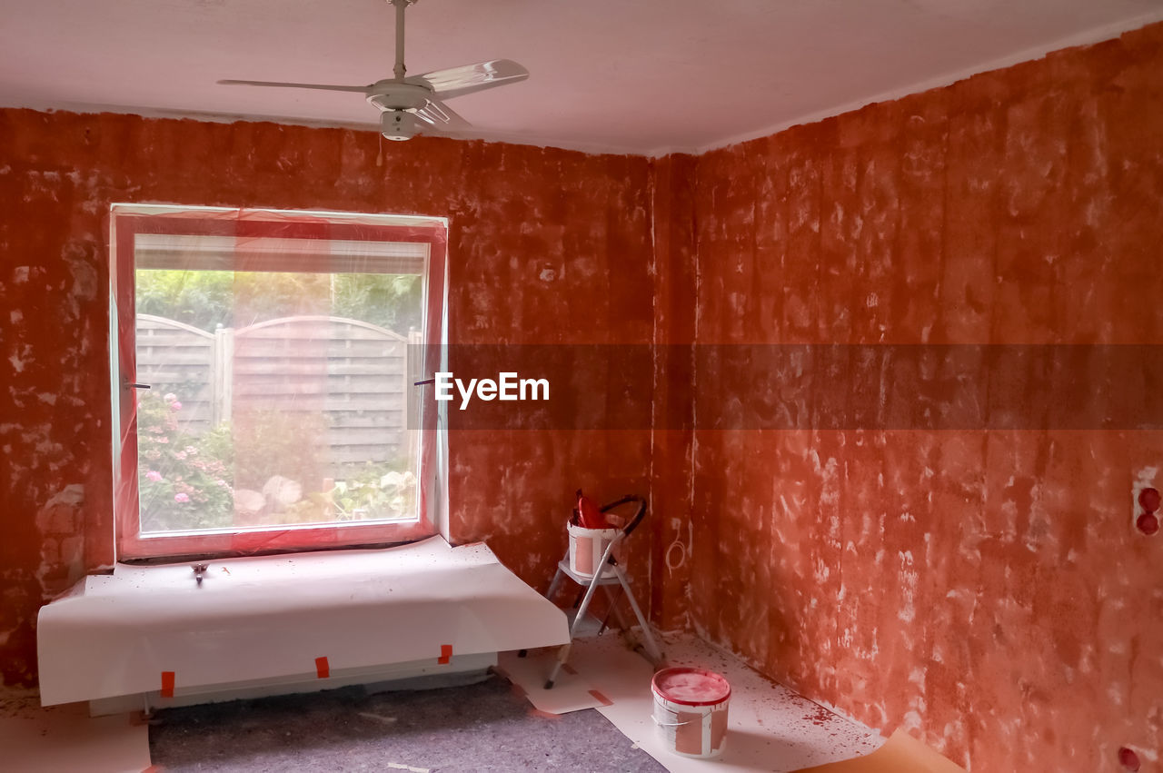 Renovation of a flat with red primer paint on the walls