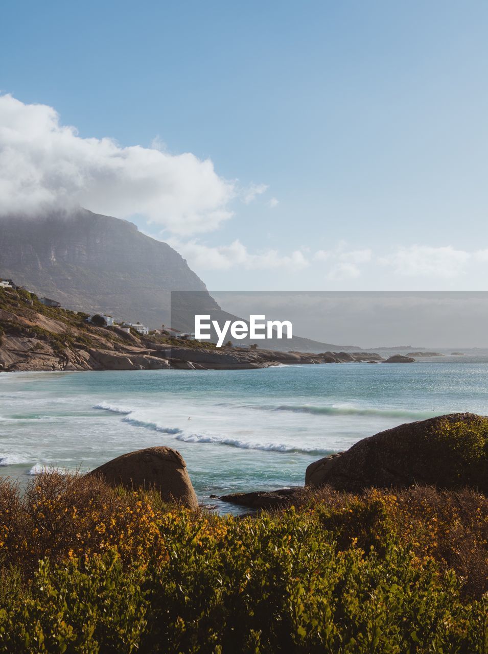 Scenic view of sea and mountains against sky