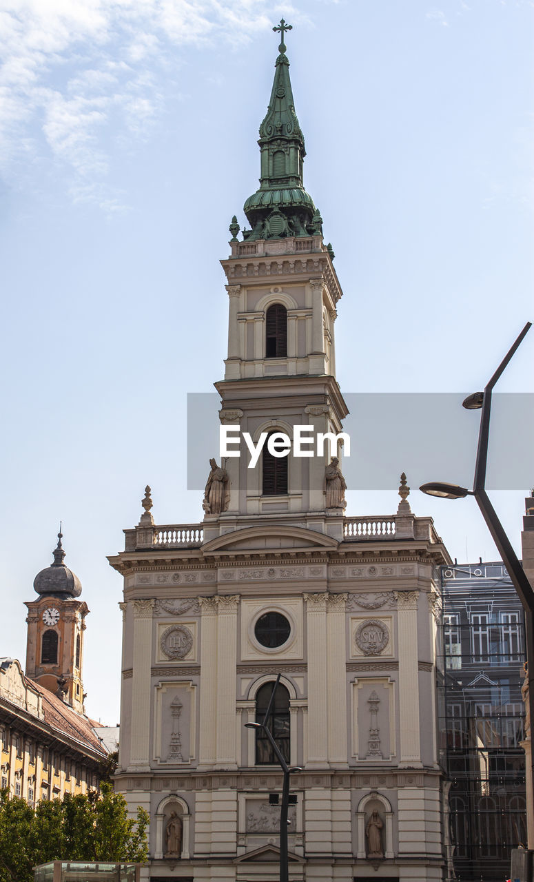 Saint anne church and the ancient tower of budapest town hall in the old town. hungary europe.