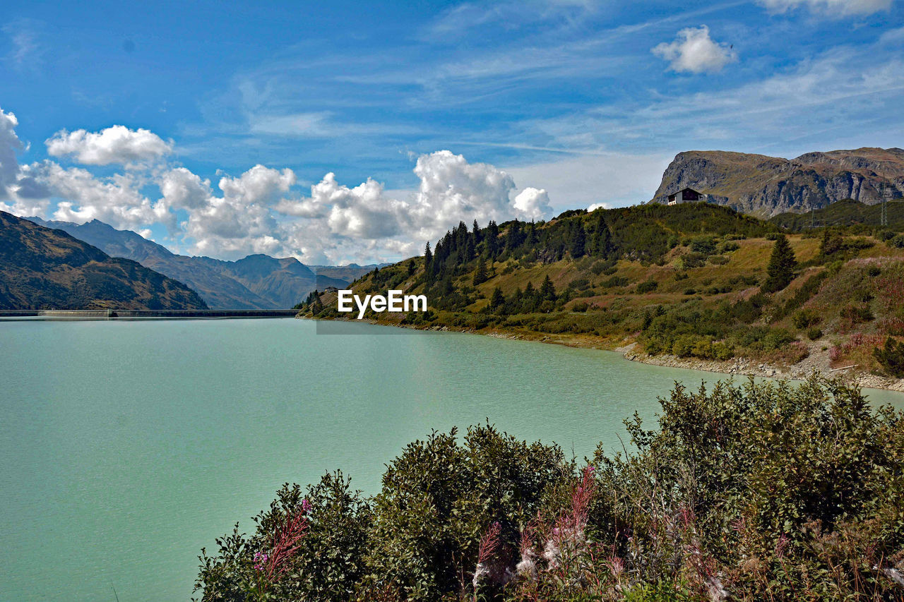 Scenic view of lake and mountains against sky