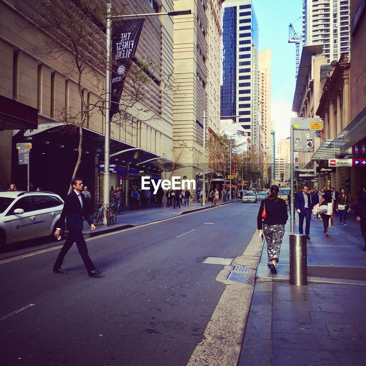 WOMAN WALKING ON CITY STREET
