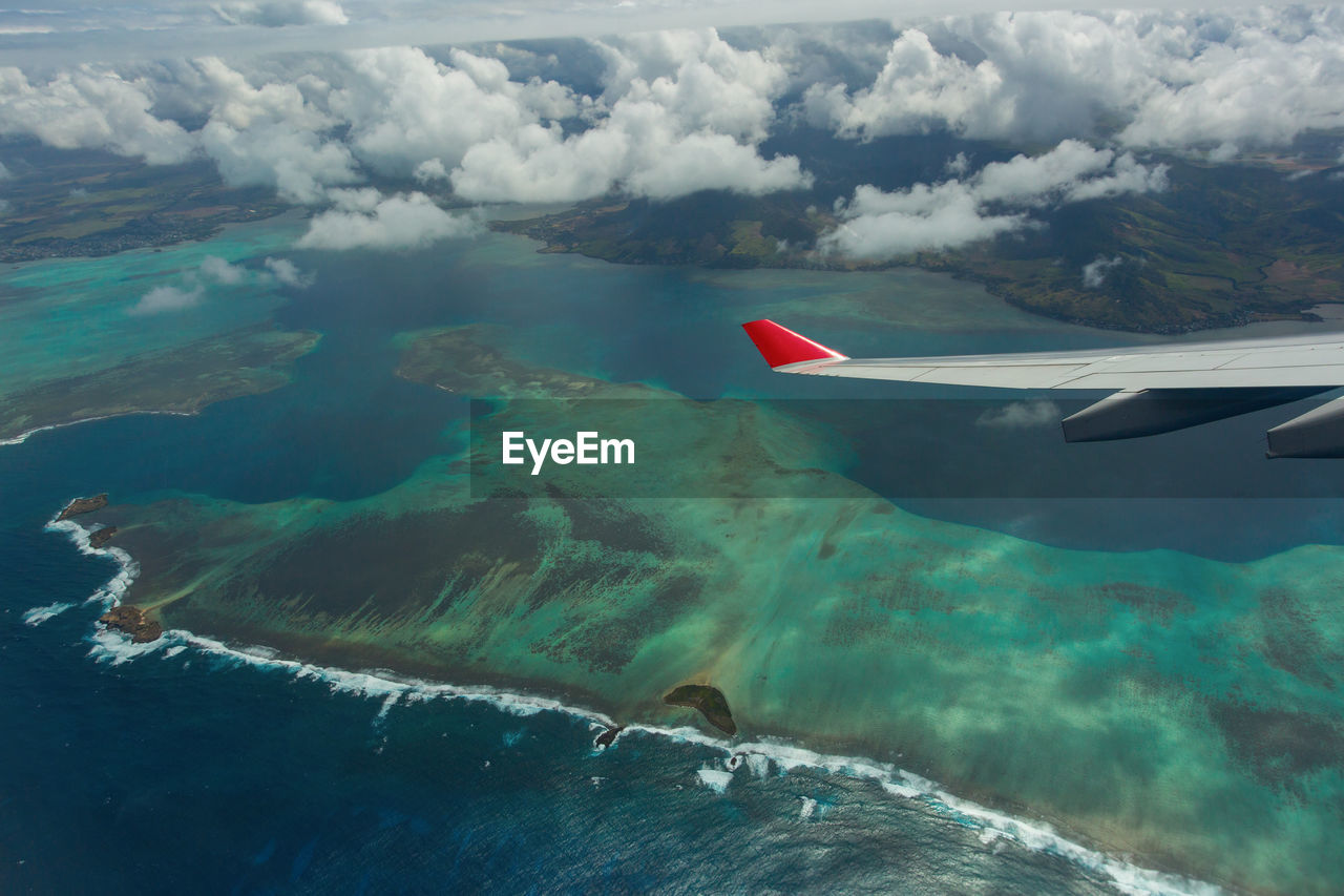 Aerial view of seascape against cloudy sky