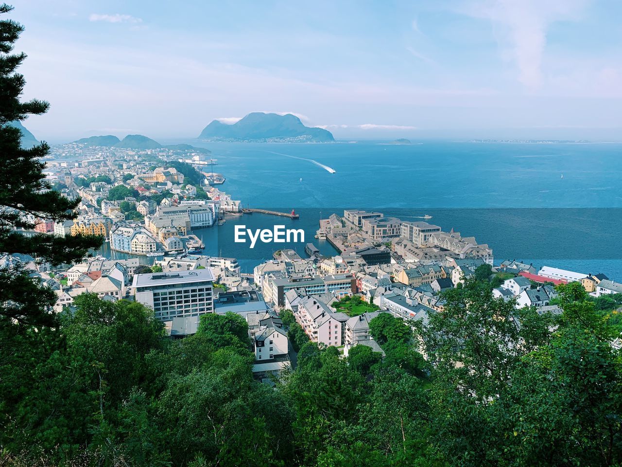 High angle view of townscape by sea against sky