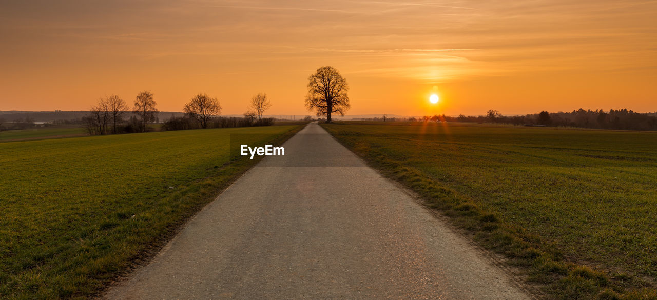 Scenic view of field against sky during sunset