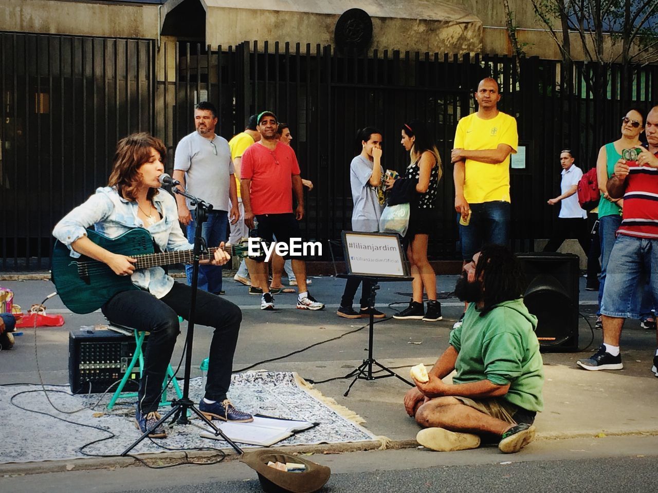 PEOPLE PLAYING GUITAR AT CONCERT