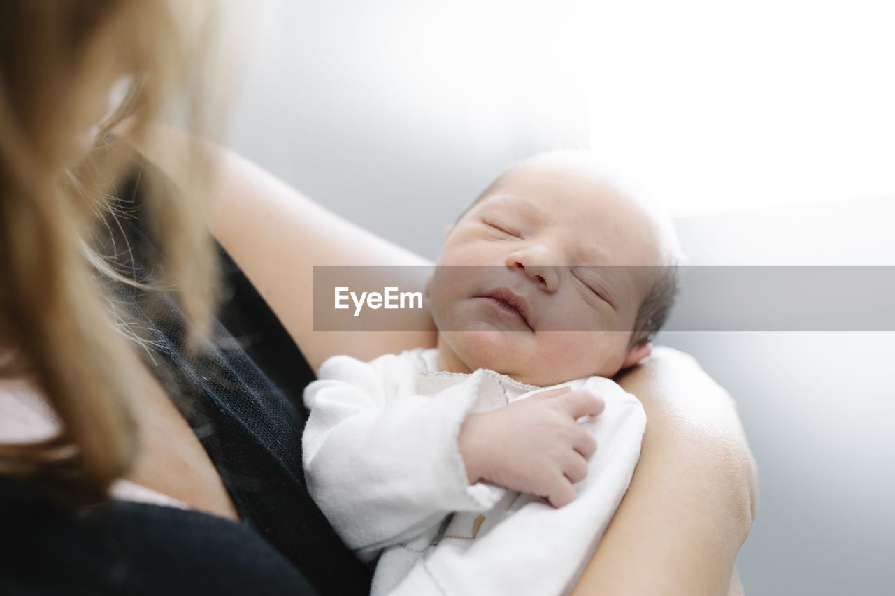 Mother with newborn baby at home