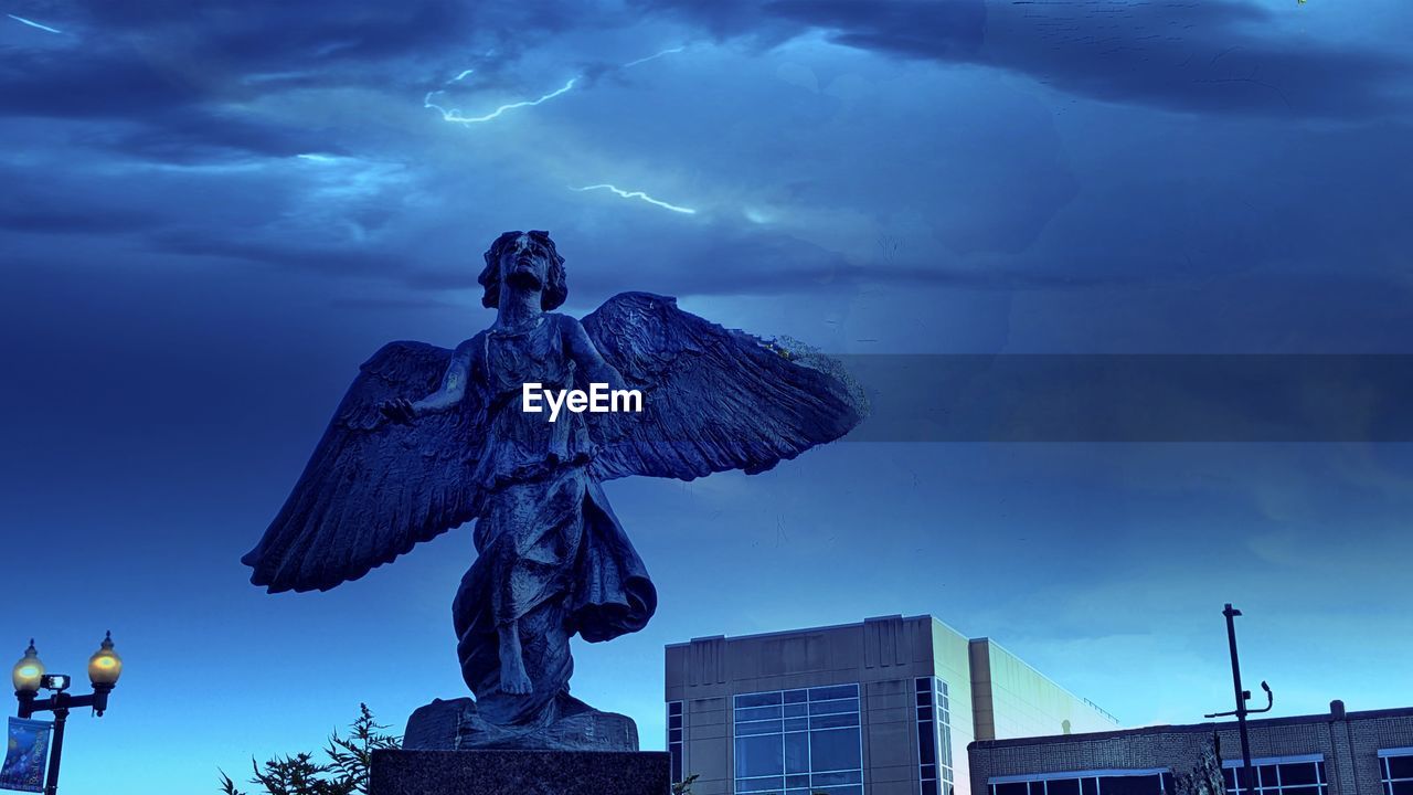 sky, architecture, cloud, sculpture, statue, city, nature, blue, storm, built structure, representation, building exterior, human representation, darkness, outdoors, building, no people, screenshot, travel destinations, creativity, night