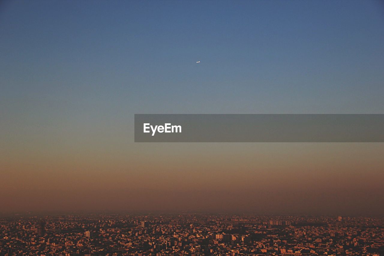 Cityscape against sky during sunset