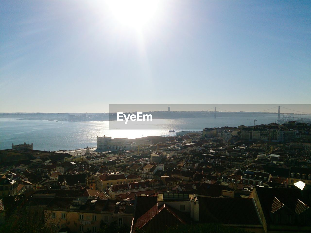 High angle view of town by sea against clear sky