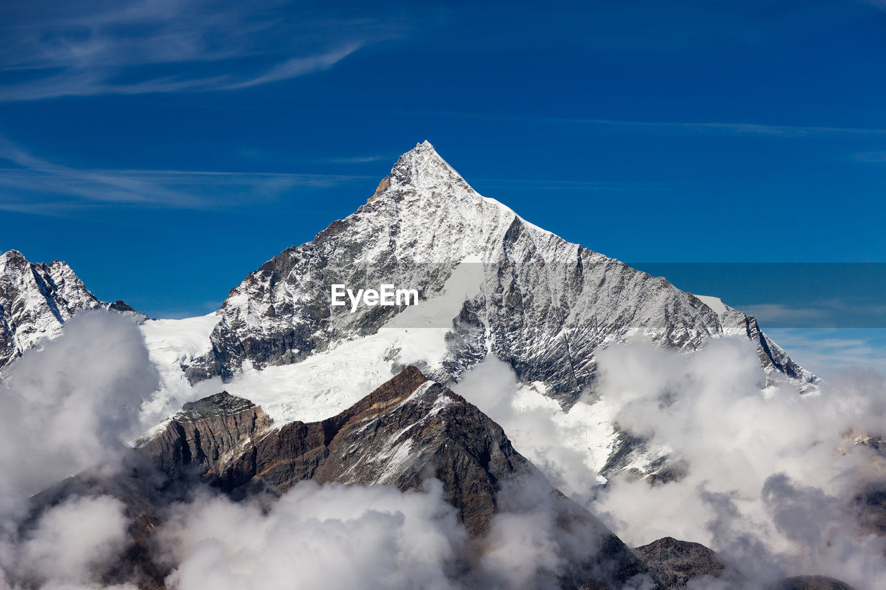 Scenic view of snow covered mountains against sky