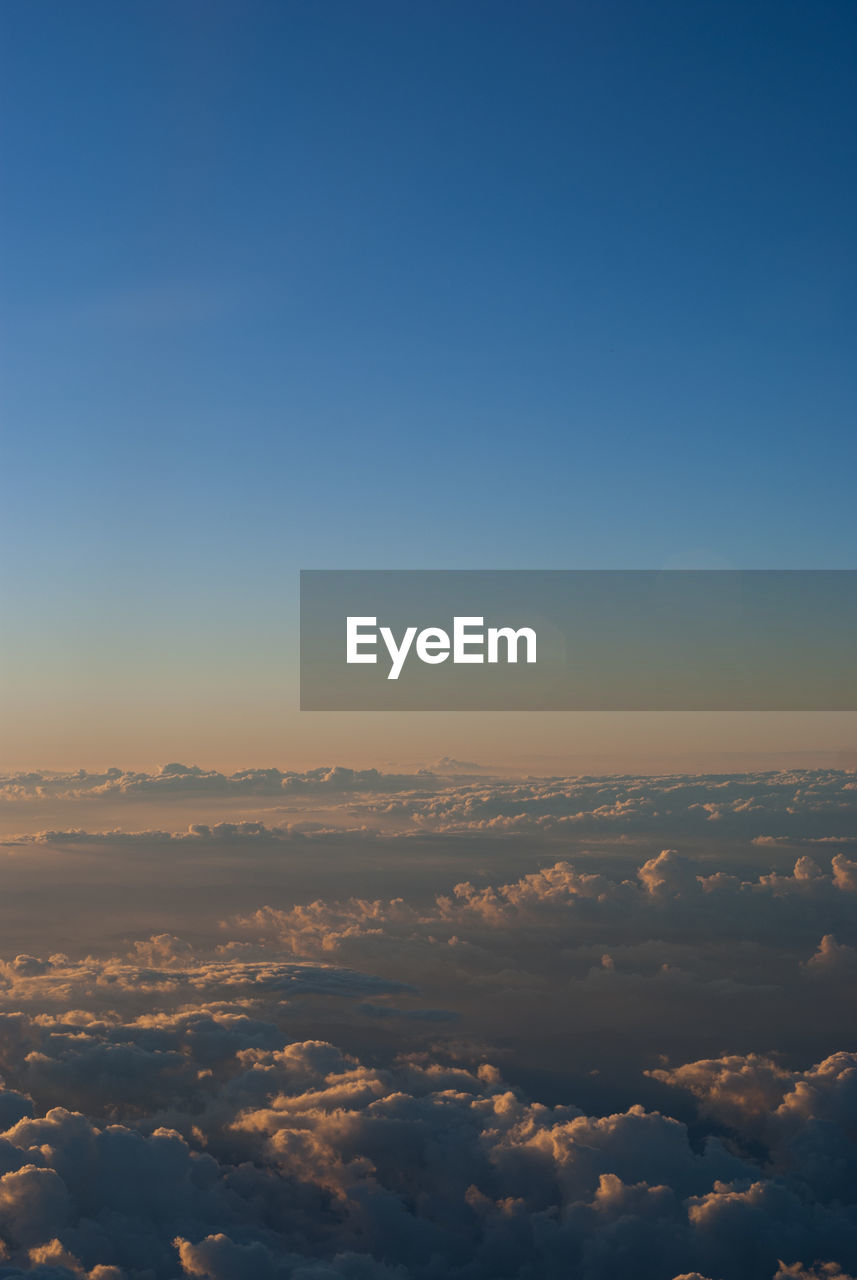 AERIAL VIEW OF CLOUDS OVER LANDSCAPE AGAINST BLUE SKY