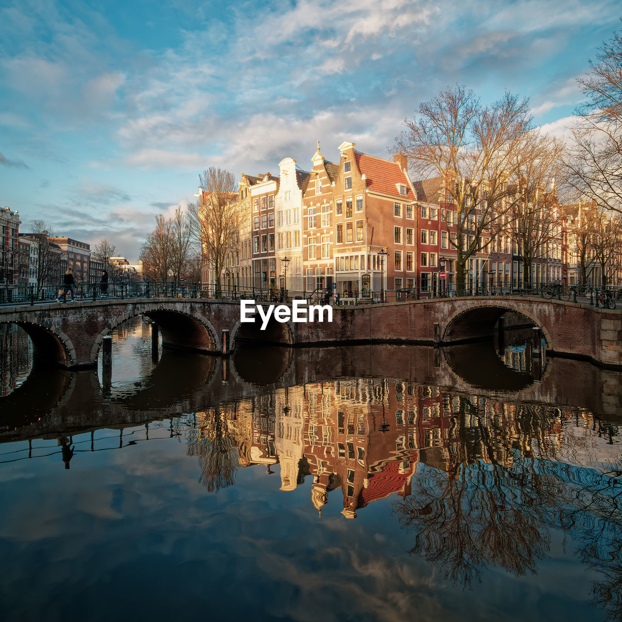 Historic canal houses against sky and reflection in water along keizersgracht canal in amsterdam