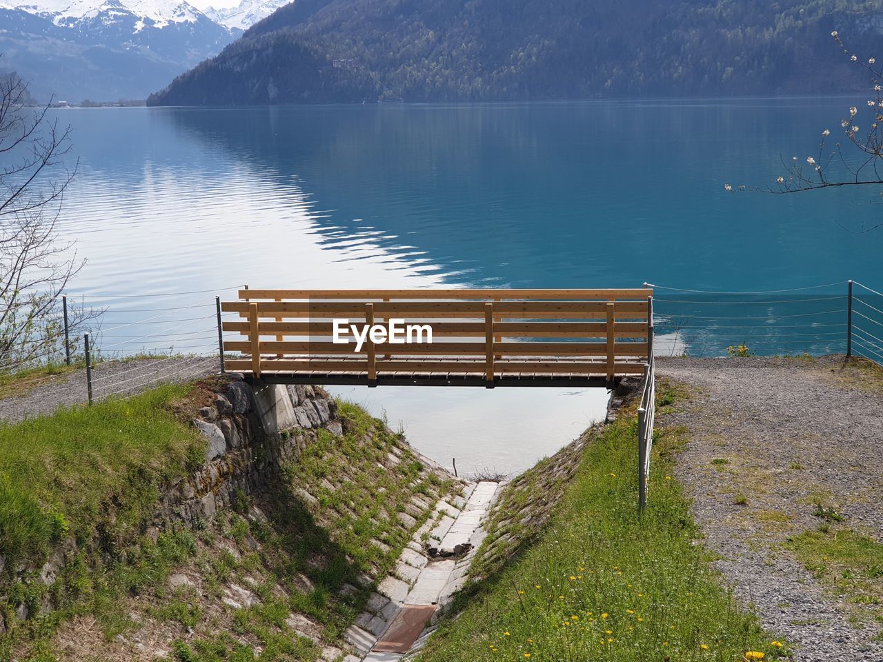 High angle view of empty bench by lake