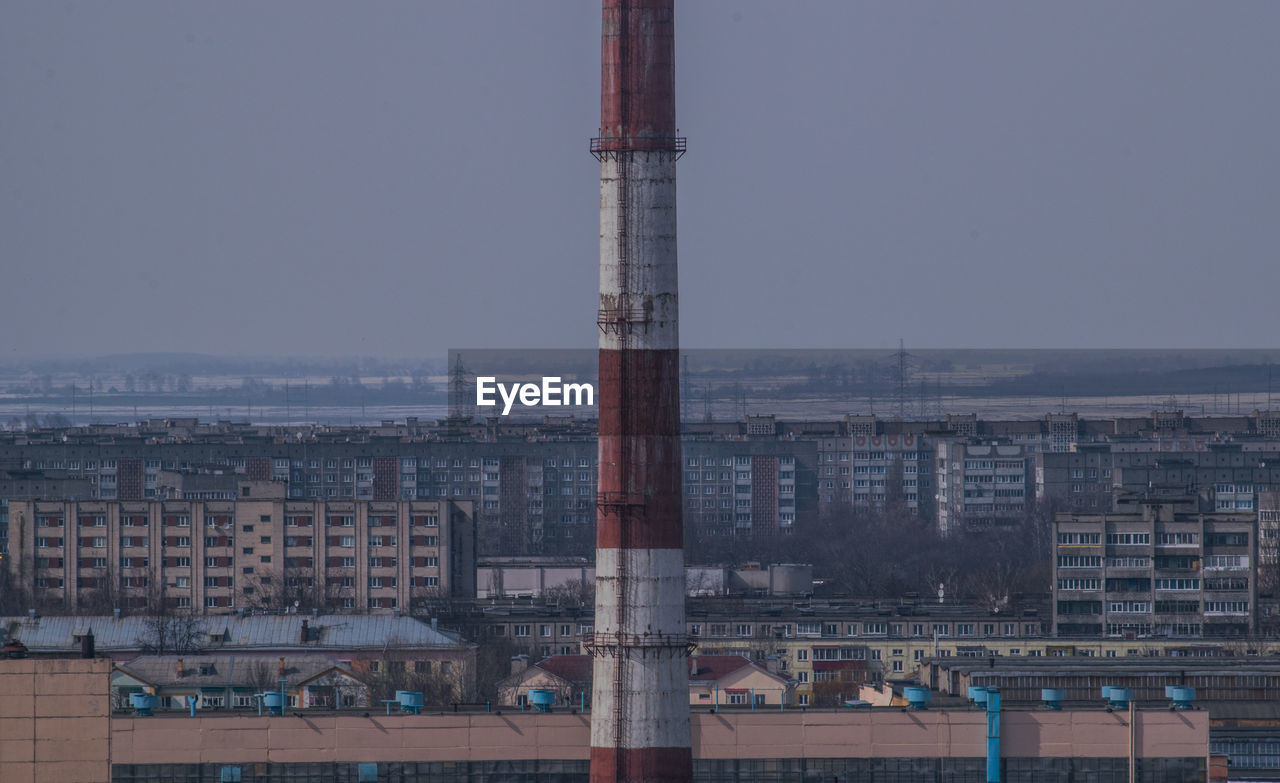 Tower amidst buildings against clear sky