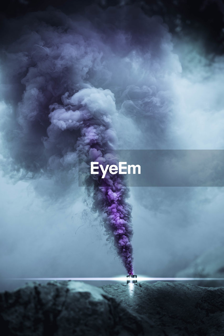 Purple smoke against sky