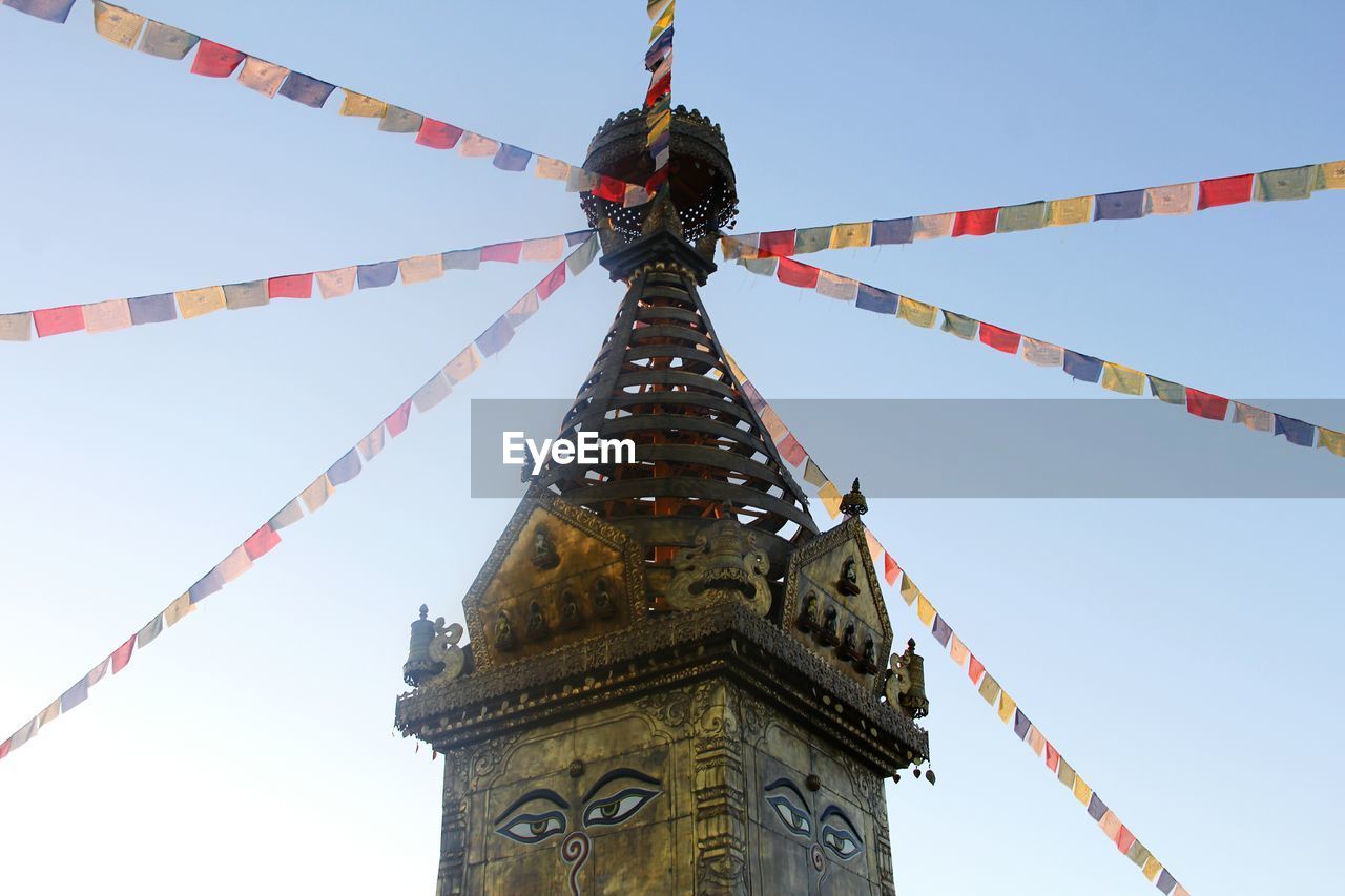 LOW ANGLE VIEW OF FLAGS HANGING AGAINST SKY