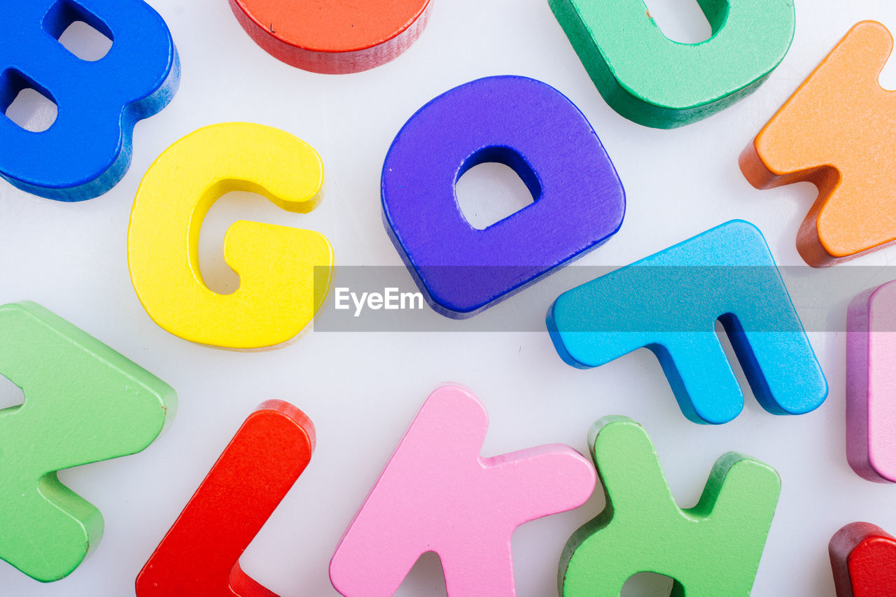 High angle view of multi colored alphabets on table