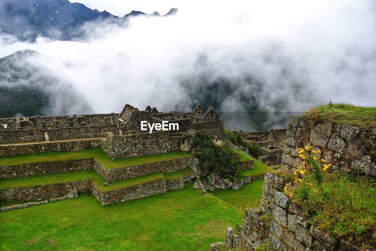 Scenic view of mountain against cloudy sky