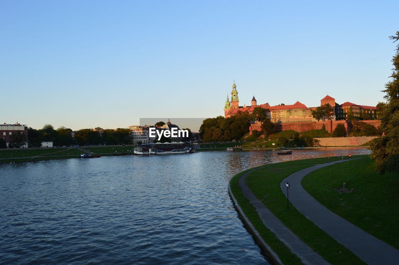 VIEW OF TOWNSCAPE WITH RIVER IN FOREGROUND