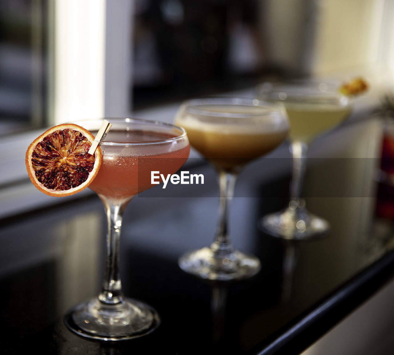 CLOSE-UP OF WINE GLASSES ON GLASS