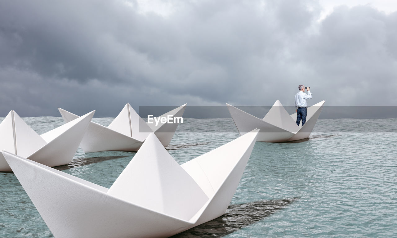 PEOPLE ON BOAT AGAINST SEA