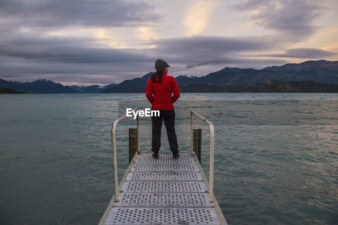 Woman standing on pier at lago rio tranquillo, carretera austral