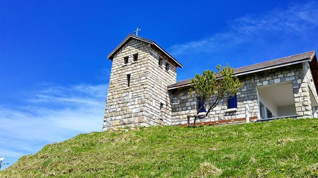 LOW ANGLE VIEW OF BUILT STRUCTURES AGAINST BLUE SKY