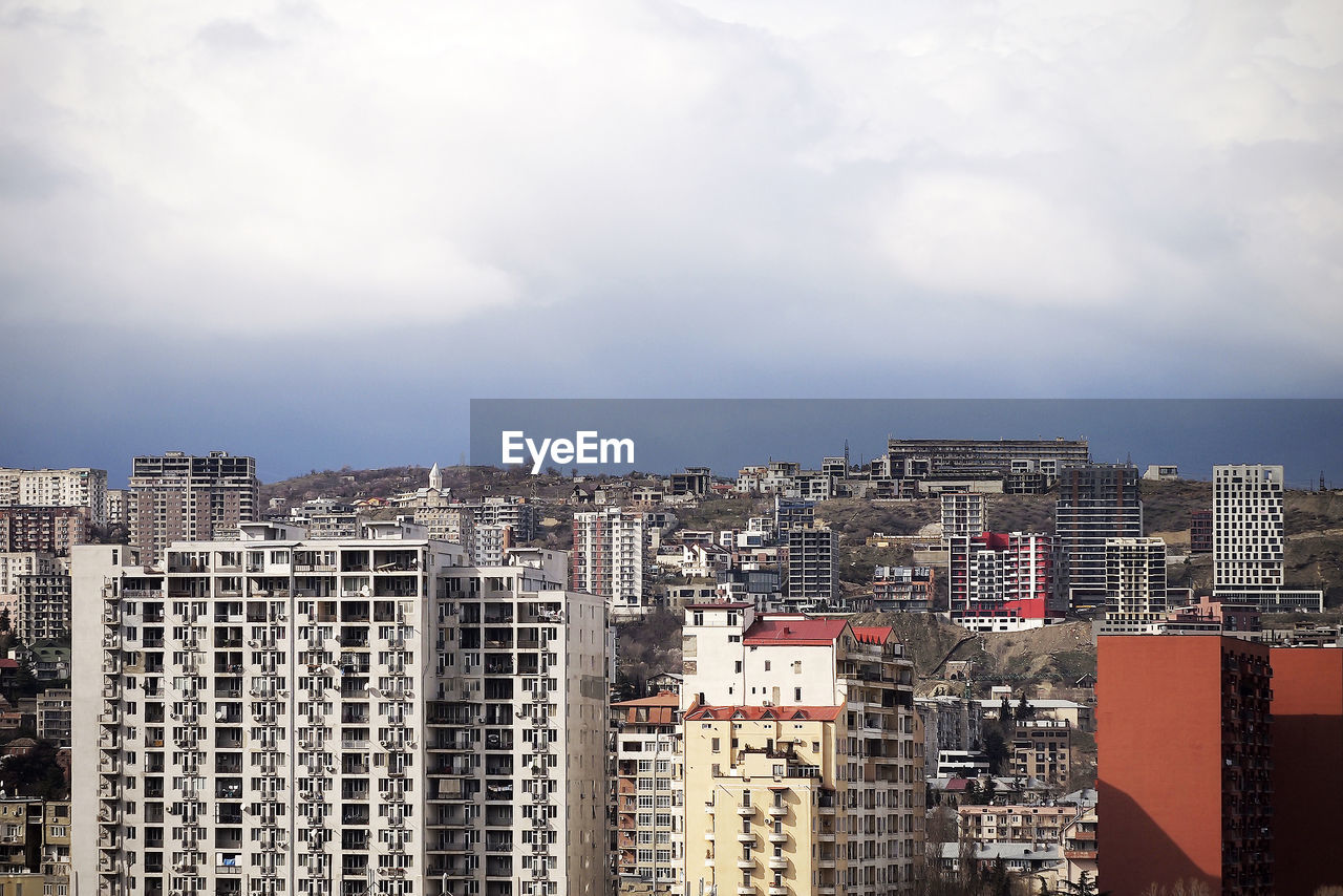 A cityscape with dramatic sky