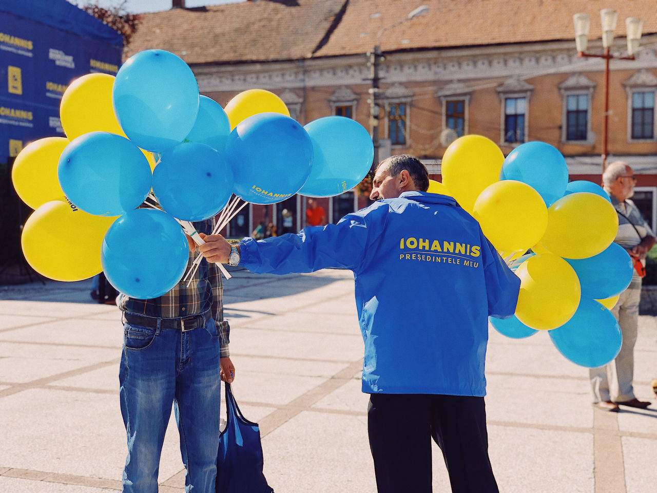 GROUP OF PEOPLE HOLDING BALLOONS